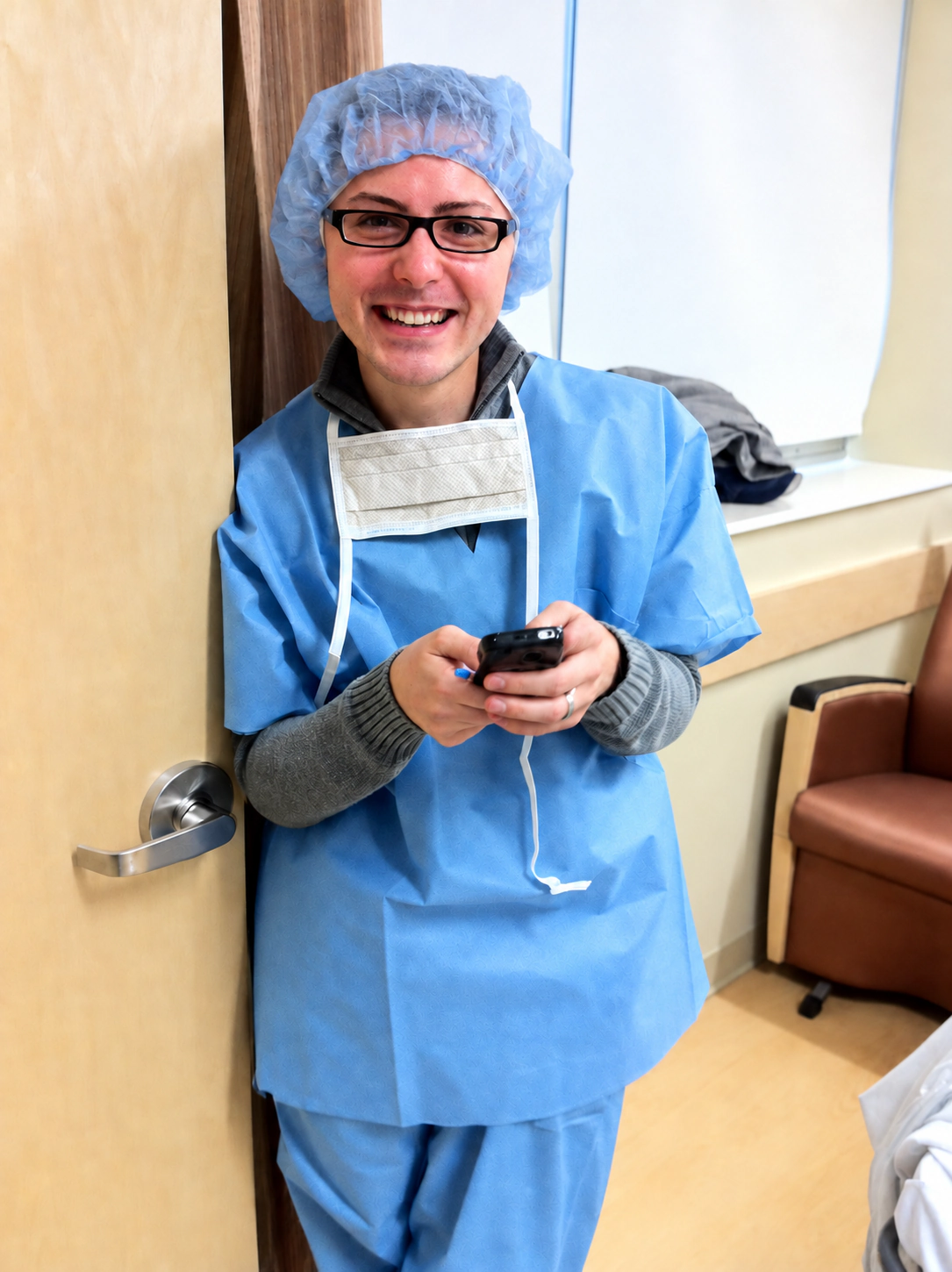 Frank Golden smiling in a hospital gown and cap before welcoming his child.