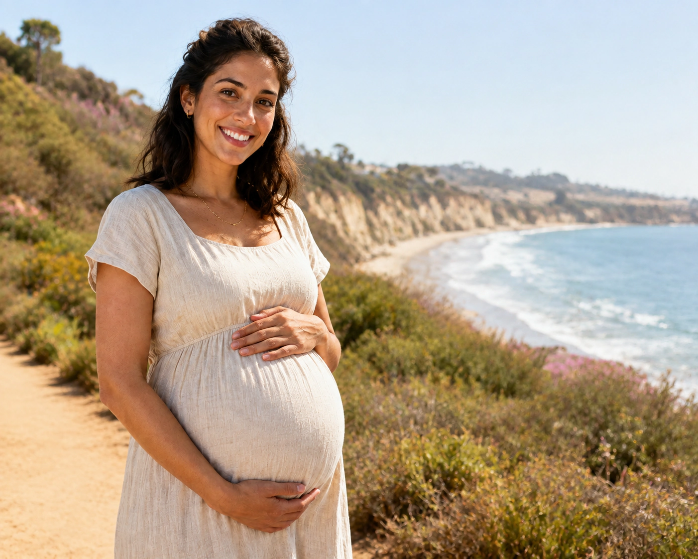 A smiling pregnant woman beside a decorative outline of California.