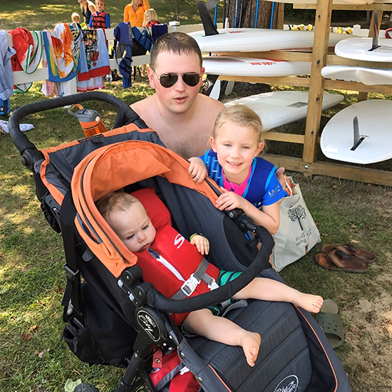 sophia-silas-adam dad sits next to his daughter and son in a stroller.