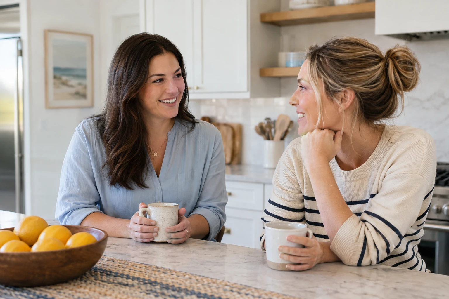 A woman and her partner talk together at their kitchen counter.