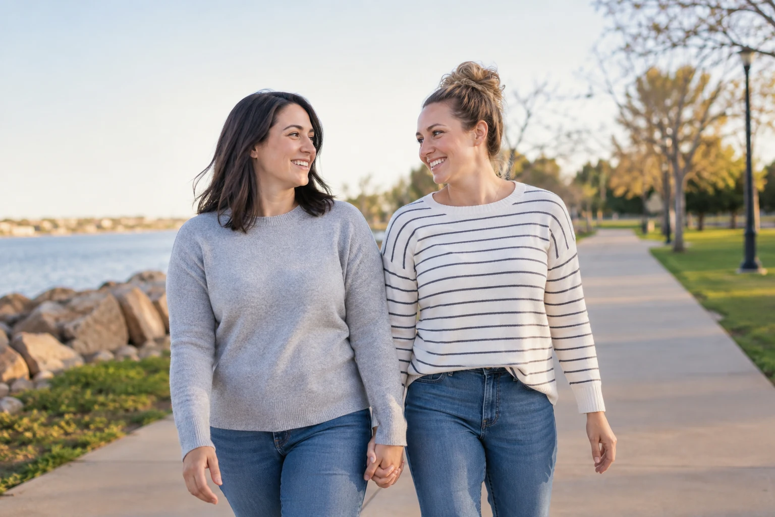 A couple takes a relaxed walk on a paved neighborhood trail.